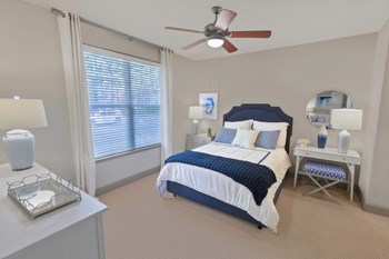 a bedroom with a large window and a ceiling fan - Photo Gallery 20