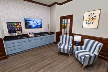 a patient waiting room with two chairs and a television - Photo Gallery 4