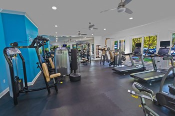 a room filled with lots of different types of exercise equipment - Photo Gallery 5
