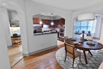 a kitchen and dining area in a 555 waverly unit - Photo Gallery 16