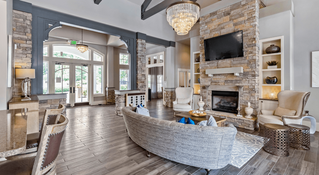 a living room with a large stone fireplace and a couch