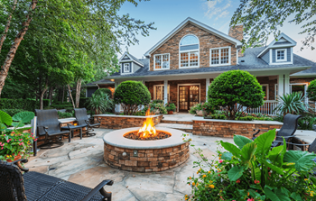 a backyard with a fire pit and patio furniture - Photo Gallery 7