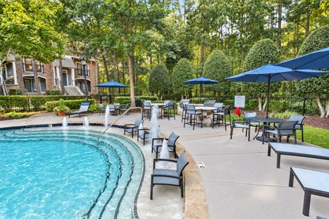 A pool with a bench and a table around it.