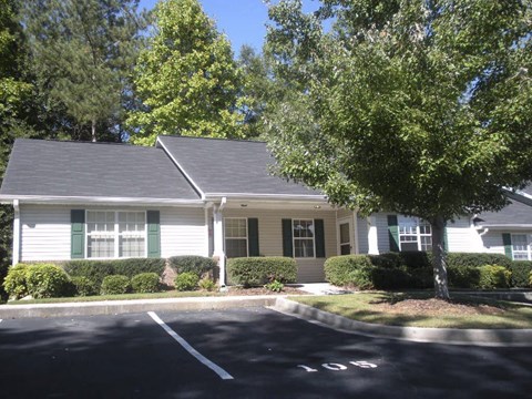 a white house with green shutters