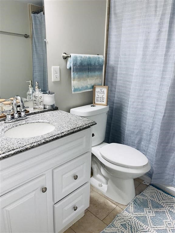 a bathroom with a toilet and a sink and a shower