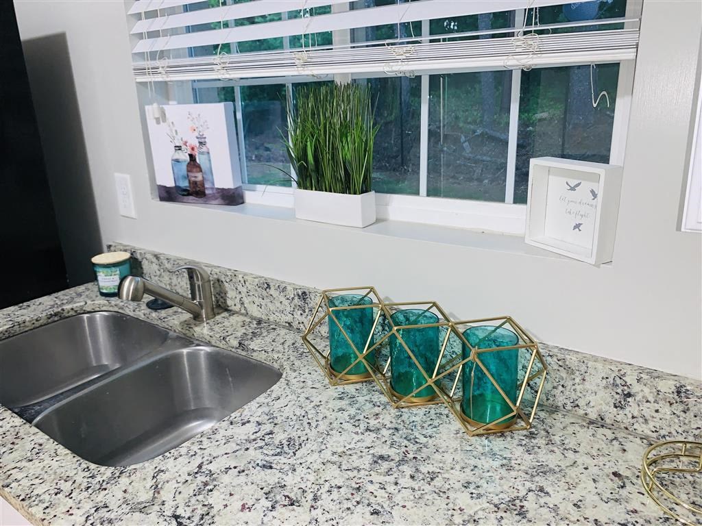 a kitchen counter with a sink and a window