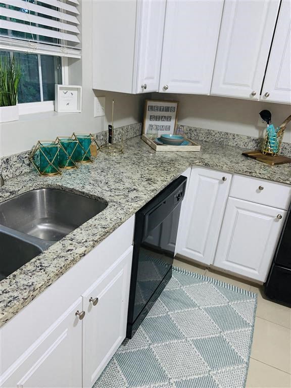 a kitchen with white cabinets and a sink