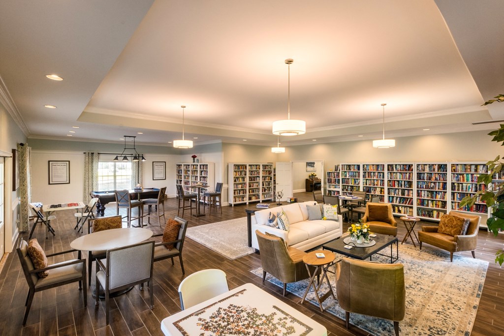 a resident clubhouse with couches chairs and tables