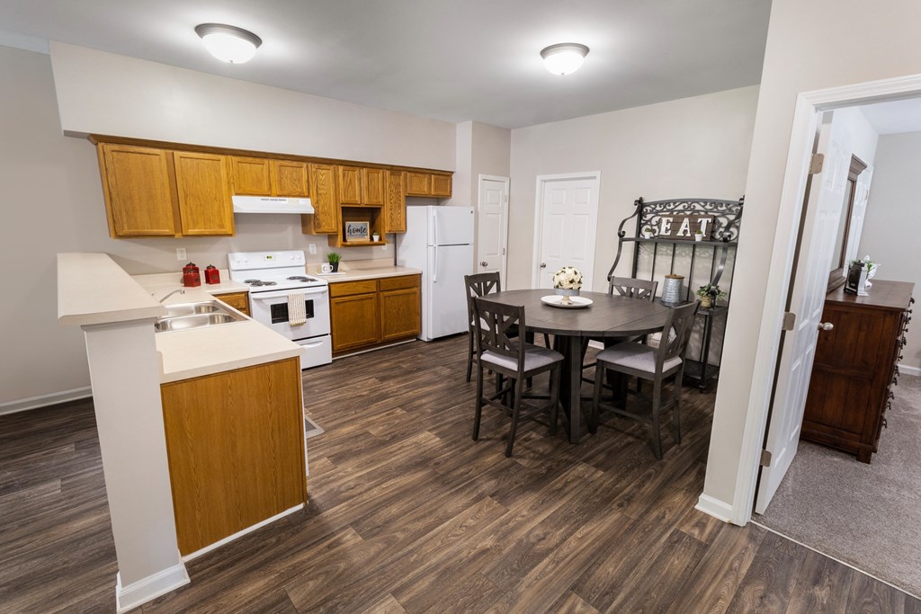 a kitchen and dining area in a bedroom apartment