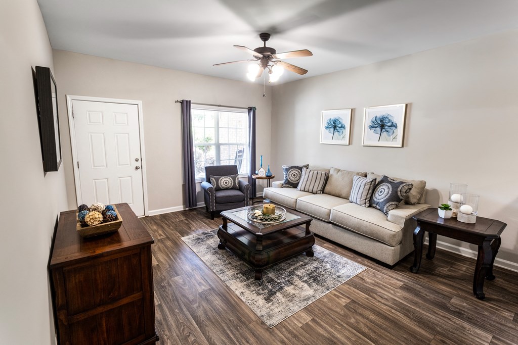 a living room with hardwood floors and a ceiling fan