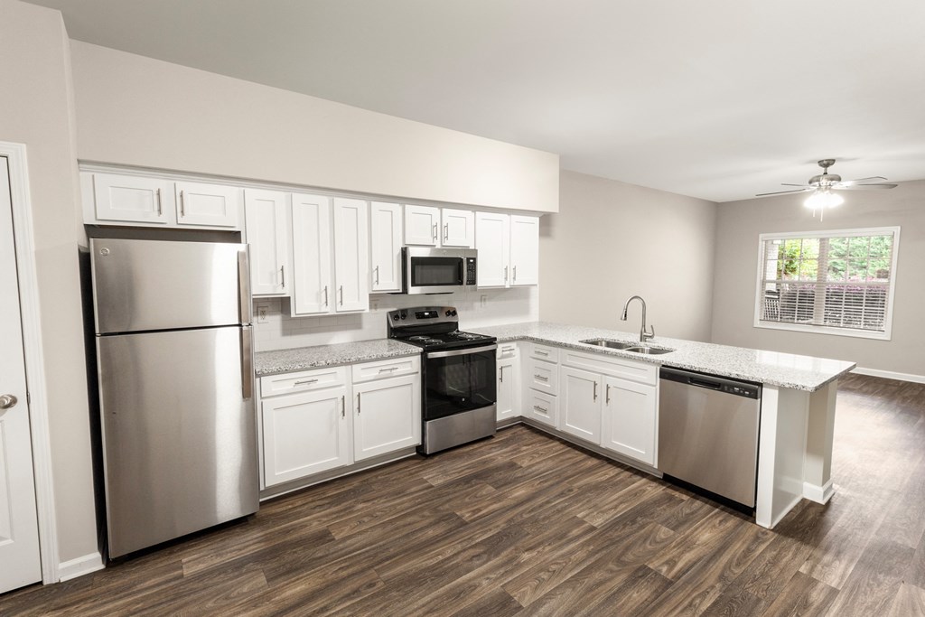 a kitchen with white cabinets and stainless steel appliances