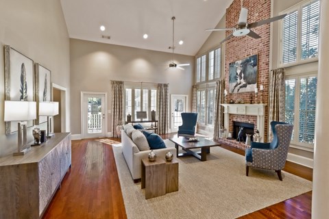 an open living room with a brick fireplace and a couch