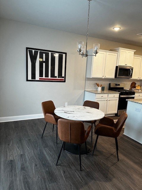 a kitchen and dining room with a table and chairs