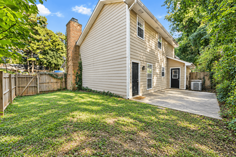A house with a small front yard and a fence.