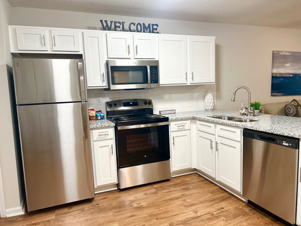 a kitchen with stainless steel appliances and white cabinets