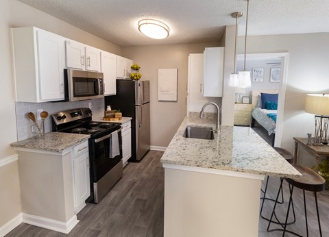 an open kitchen with granite counter tops and stainless steel appliances