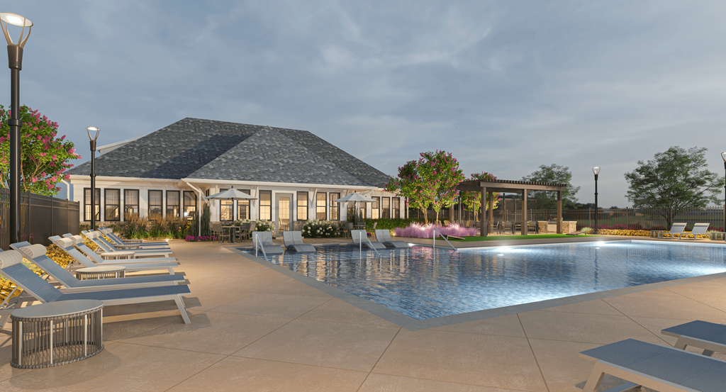 a swimming pool with lounge chairs and a building in the background