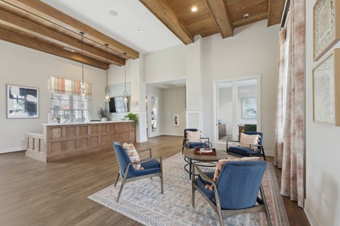 A living room with a blue chair and a brown cabinet.
