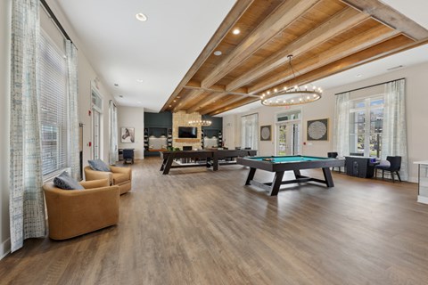 A spacious room with a pool table and a billiard table.