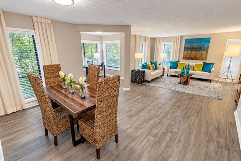 A dining room with a wooden table and chairs.