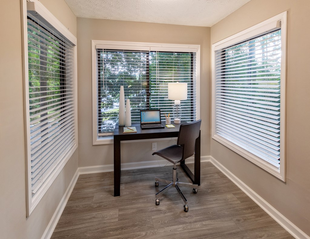 a desk with a laptop computer and a lamp on top of it in a room with large at Seven Pines, Alpharetta, GA