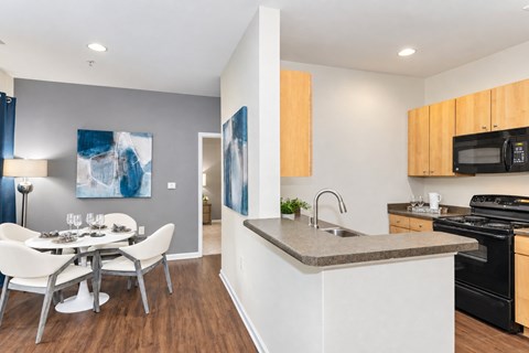 A modern kitchen with a dining table and chairs.