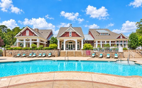 A large house with a pool in front.