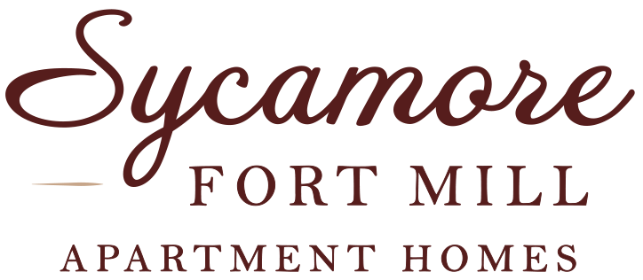 A logo for Sycamore Fort Mill Apartment Homes.