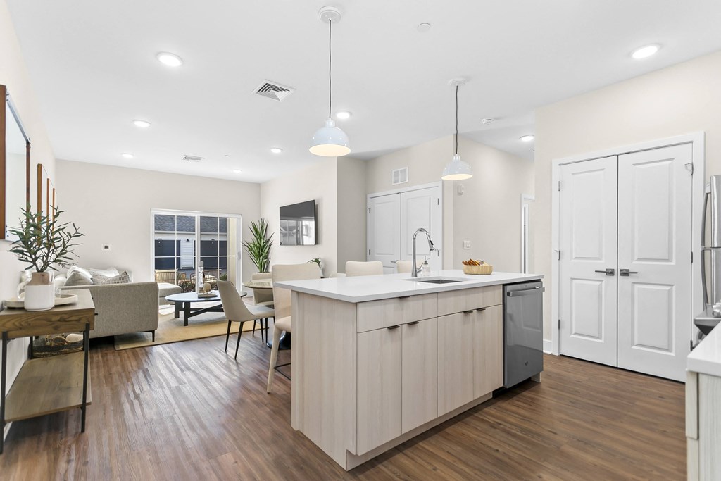 A modern kitchen with a dining area and a living room.