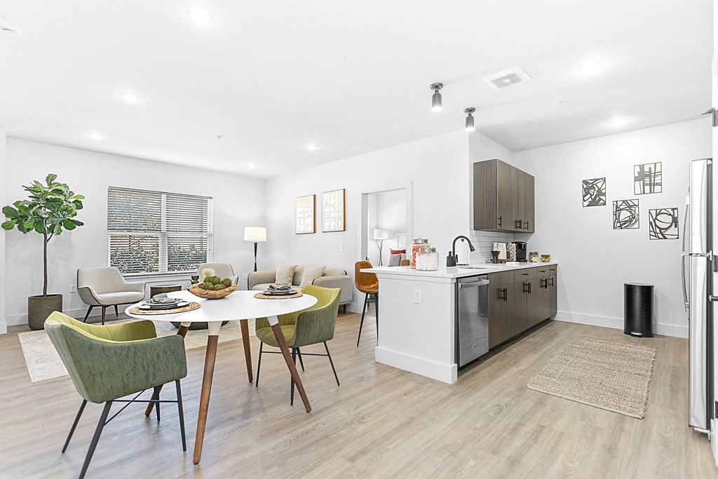 A modern kitchen with a dining table and chairs.