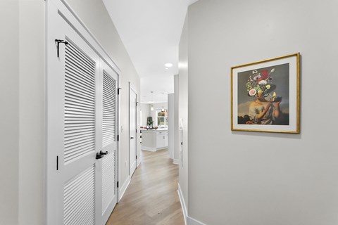 A hallway with a painting on the wall.