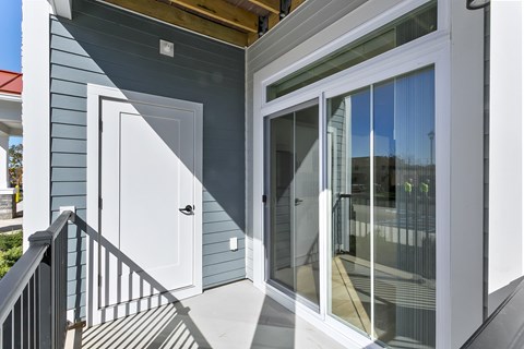 A white door is on the left and a sliding glass door is on the right.