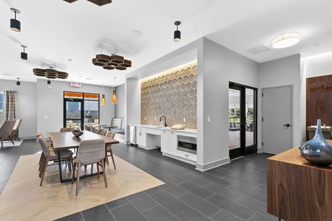 A modern kitchen with a dining table and chairs.