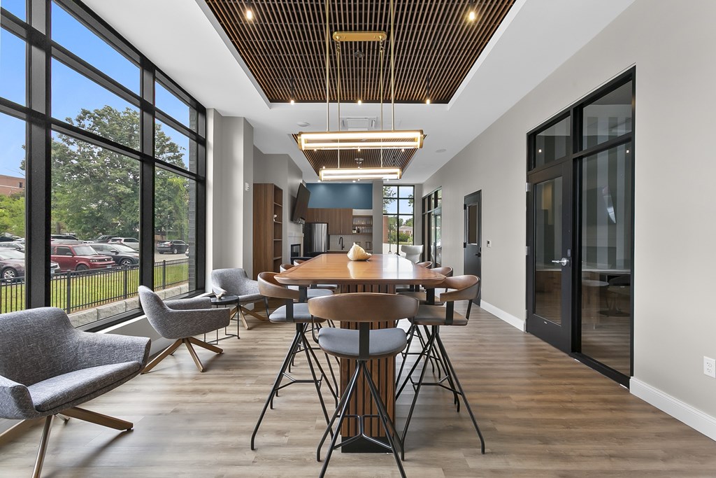 A modern dining room with a wooden table and chairs.
