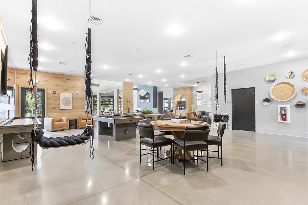 A modern dining room with a large table and chairs.