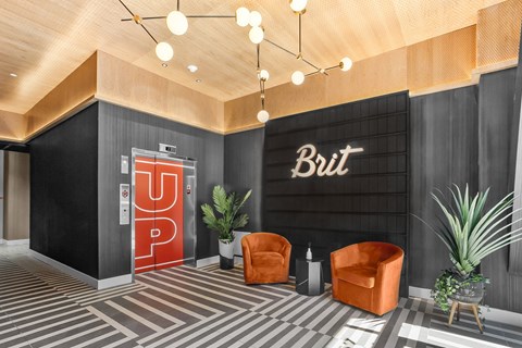 a lobby with a red door and a sign that reads but