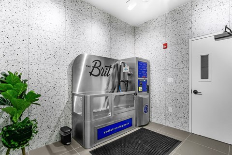 a bathroom with a refrigerator and a plant