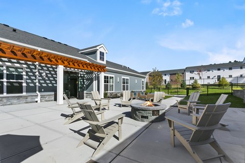 A patio with chairs and a fire pit.