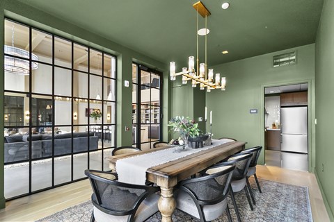 A dining room with a table and chairs.