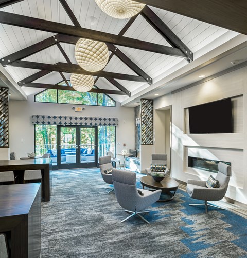 a large living room with chairs and a television