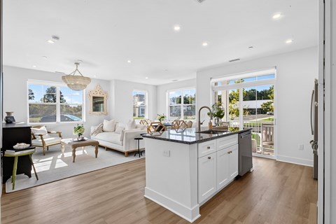 A modern kitchen with white cabinets and a large island.