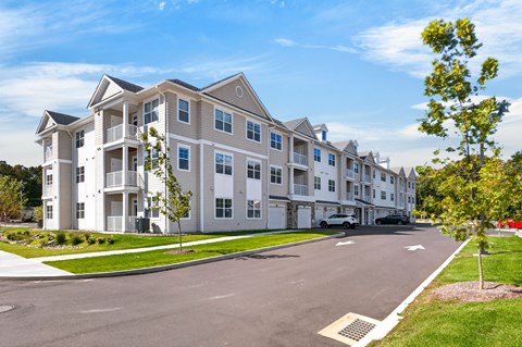 A row of townhouses with a street in front.