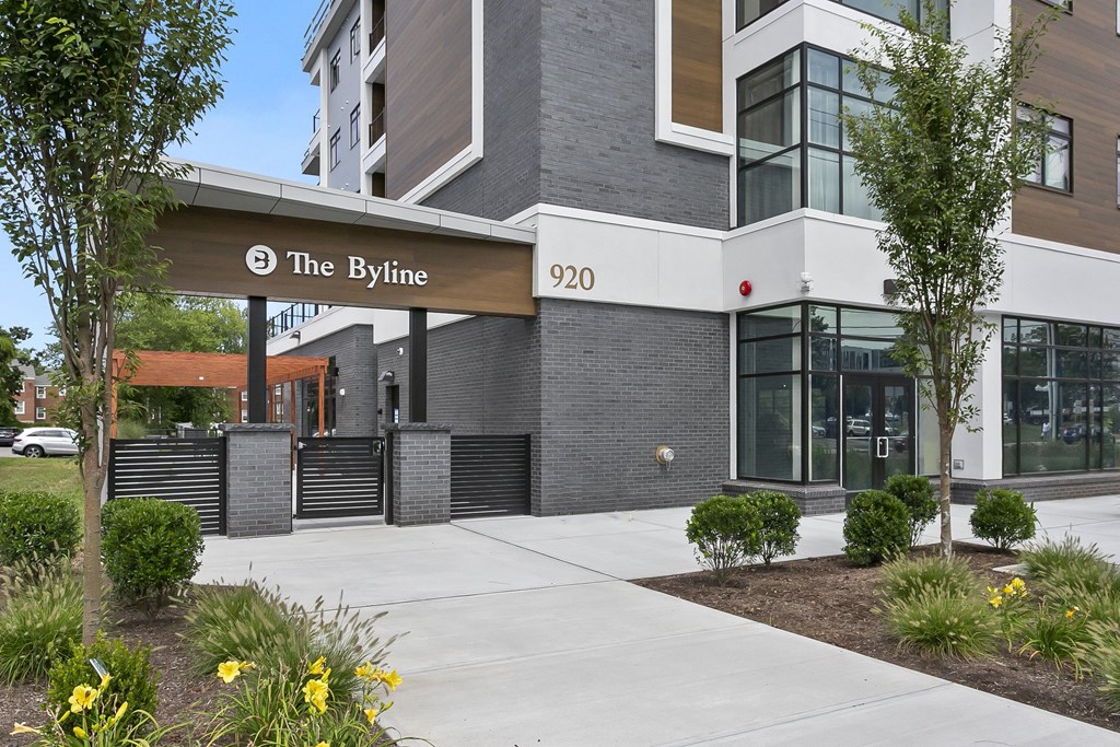 The front of a building called The Byline with a sign above the entrance.