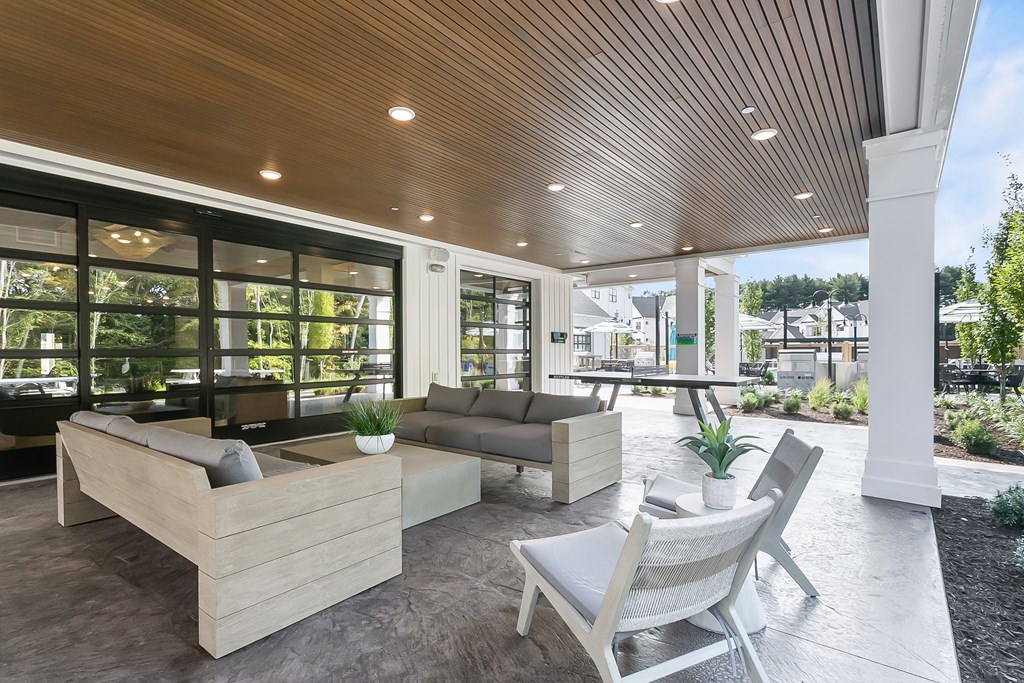 A modern outdoor seating area with a wooden bench and chair.