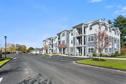 A street view of a residential area with apartment buildings.