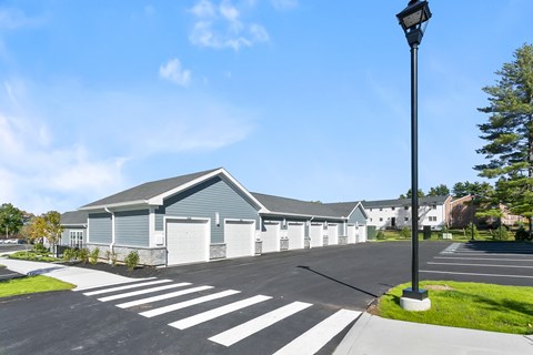 A street view of a building with a parking lot in front.