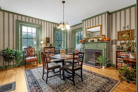 a dining room with a table and chairs and a fireplace