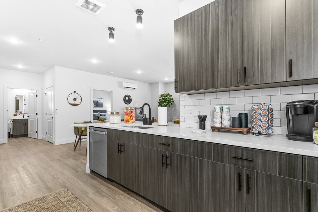 A kitchen with wooden cabinets and a white countertop.