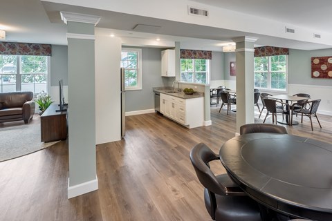 a kitchen and dining room with a table and chairs at Eden & Main 55+ Apartments, Southington , CT 06489