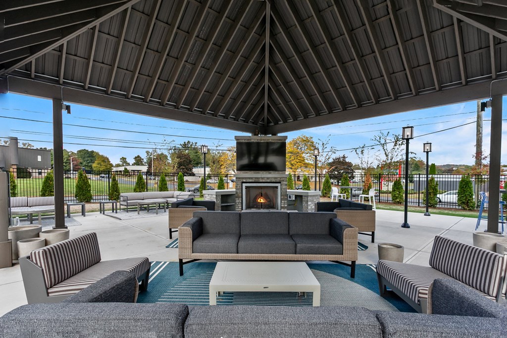 A patio with a fireplace and seating area.